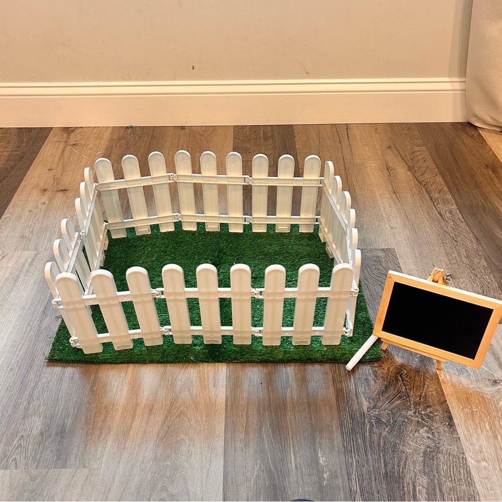 White Plastic Fence and Grass with Chalkboard Sign